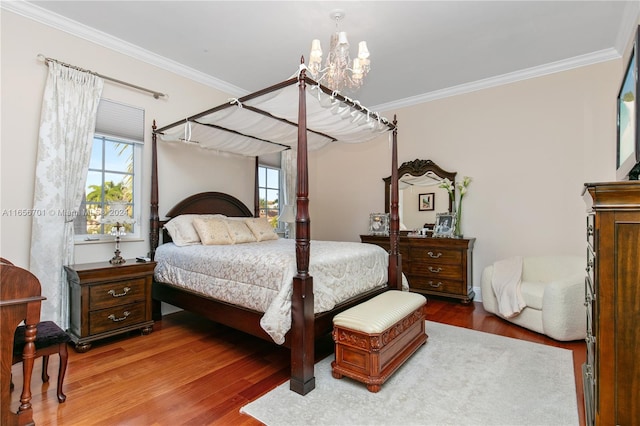 bedroom featuring dark hardwood / wood-style floors, a chandelier, and crown molding