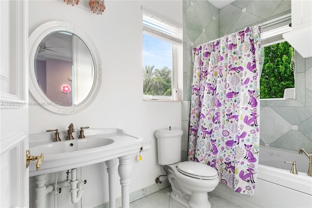 bathroom with toilet, plenty of natural light, and shower / bathtub combination with curtain