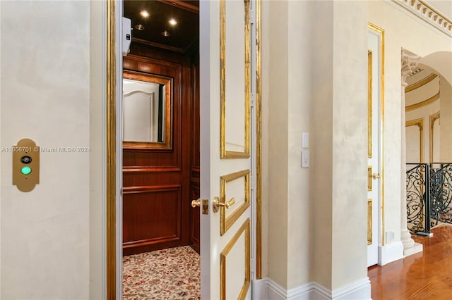 hall featuring hardwood / wood-style flooring and elevator