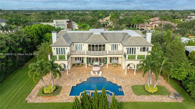 back of house featuring a patio and a balcony