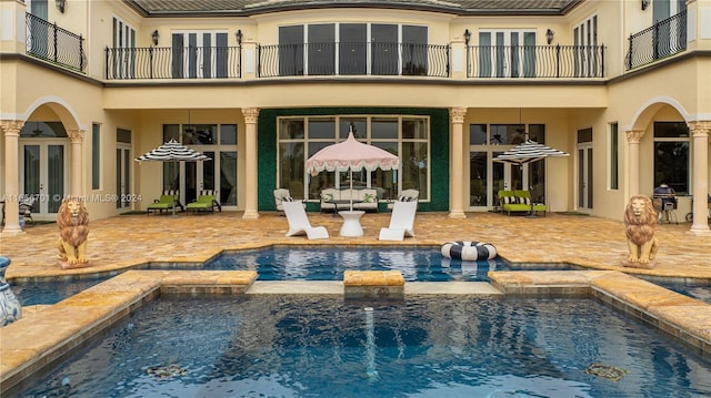 view of pool featuring a patio area, an in ground hot tub, and french doors