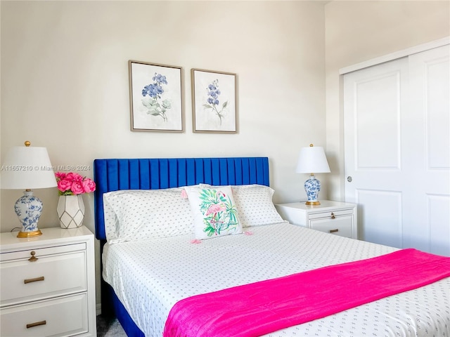 bedroom with carpet and a closet