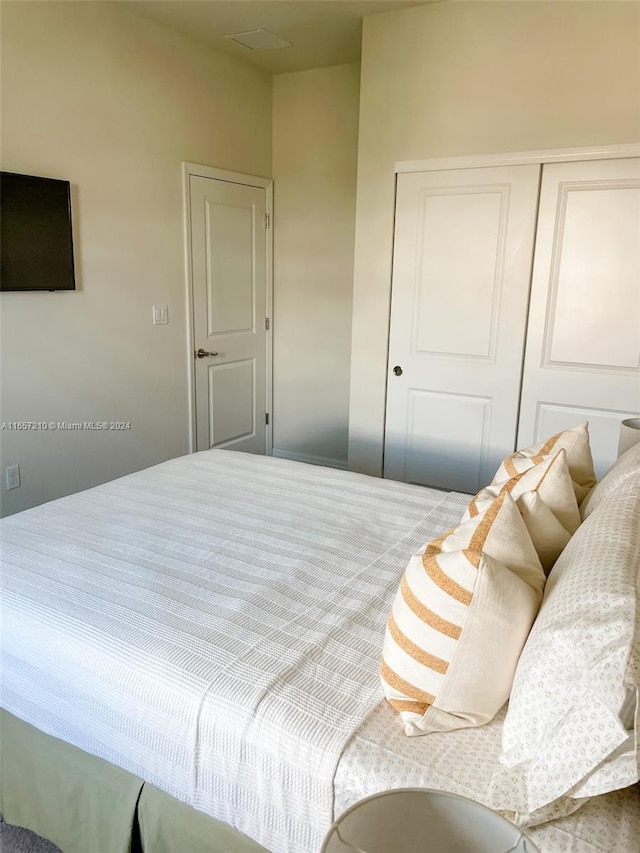 carpeted bedroom featuring a closet