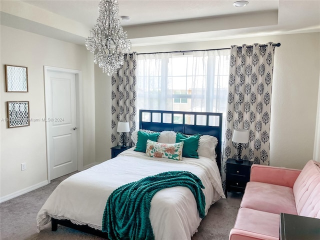 bedroom featuring a notable chandelier and carpet floors