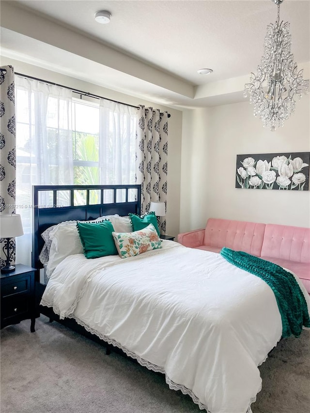 bedroom featuring carpet and an inviting chandelier