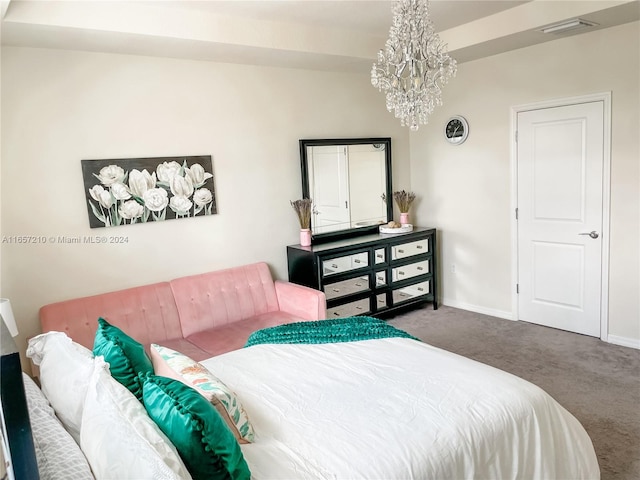 bedroom with dark carpet and a notable chandelier