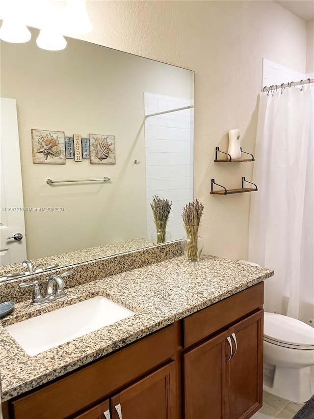 bathroom featuring a shower with shower curtain, tile patterned flooring, toilet, and vanity