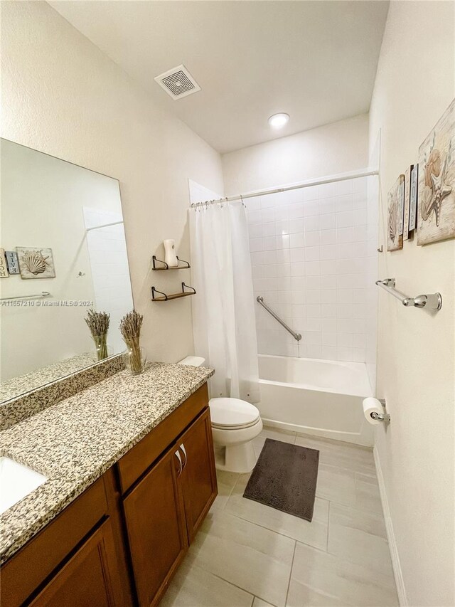 full bathroom featuring tile patterned floors, toilet, shower / tub combo with curtain, and vanity