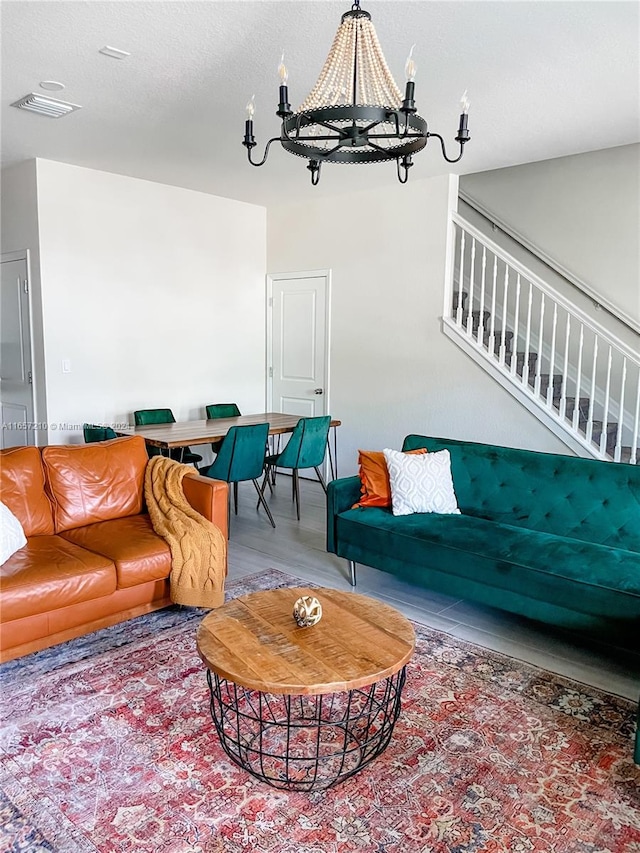 living room featuring a textured ceiling and a chandelier