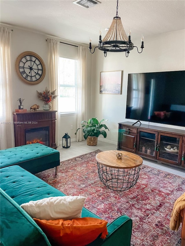 living room with a notable chandelier and a textured ceiling