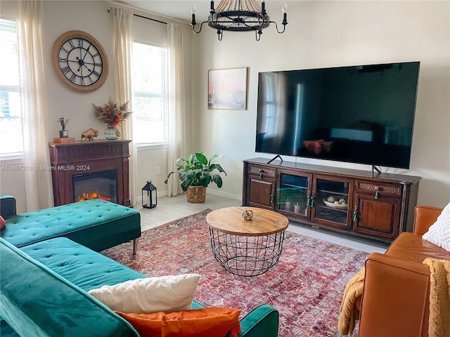 living room featuring light wood-type flooring and a chandelier