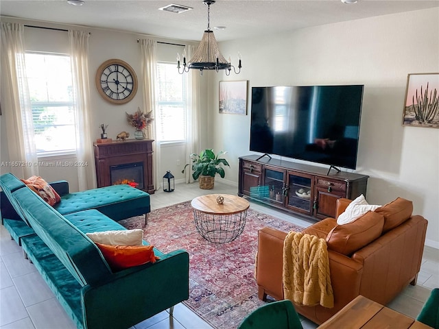 tiled living room featuring a notable chandelier