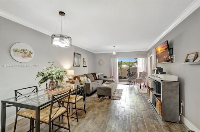 dining space with hardwood / wood-style flooring and ornamental molding