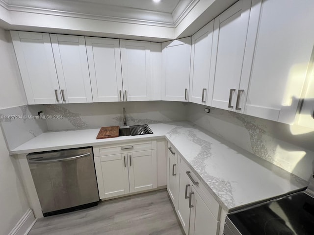 kitchen with light wood-type flooring, appliances with stainless steel finishes, light stone counters, white cabinetry, and decorative backsplash