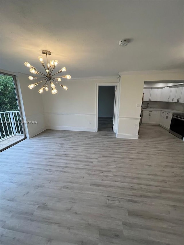 interior space with crown molding, a chandelier, sink, wood-type flooring, and access to exterior