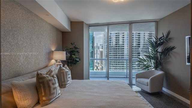 sitting room with floor to ceiling windows and carpet