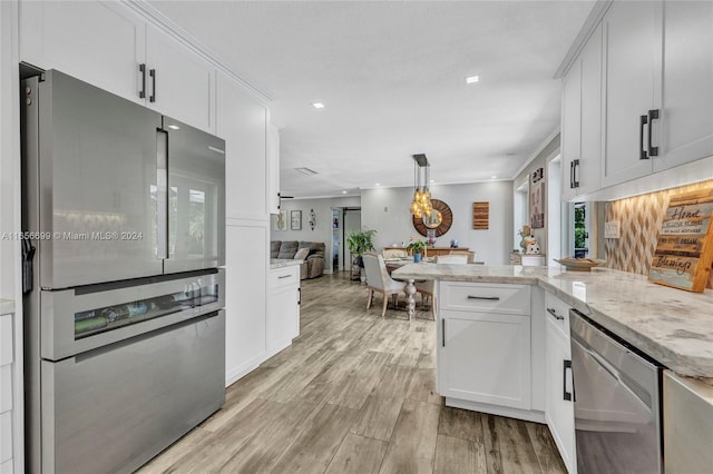 kitchen featuring stainless steel appliances, light hardwood / wood-style floors, kitchen peninsula, and white cabinetry