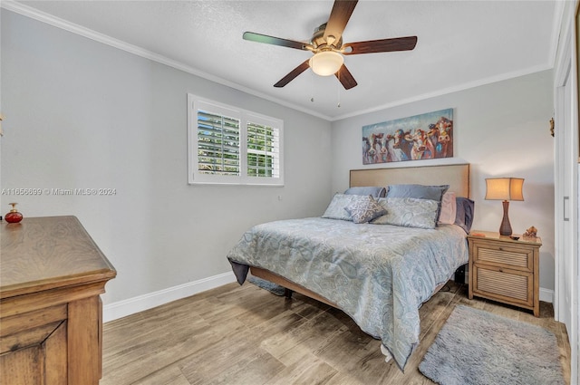 bedroom with crown molding, ceiling fan, and wood-type flooring