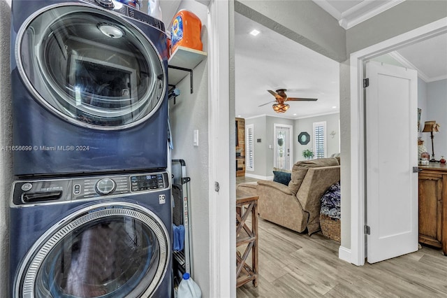 clothes washing area featuring hardwood / wood-style floors, ceiling fan, stacked washer and dryer, and ornamental molding