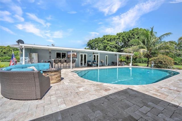 view of pool with an outdoor hangout area, an outdoor bar, and a patio