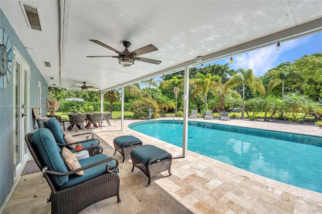 view of pool featuring ceiling fan and a patio