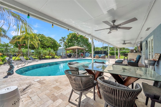 view of pool featuring ceiling fan and a patio area