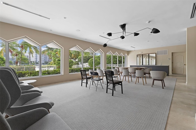 interior space featuring a ceiling fan, visible vents, and finished concrete flooring