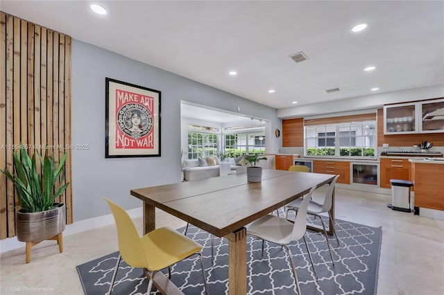 dining area featuring wine cooler and plenty of natural light