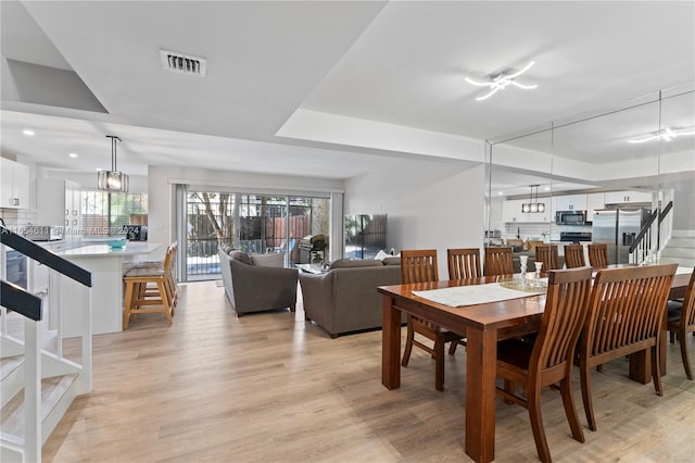 dining room featuring light hardwood / wood-style flooring and an inviting chandelier