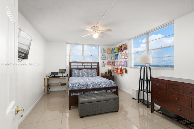 tiled bedroom featuring ceiling fan