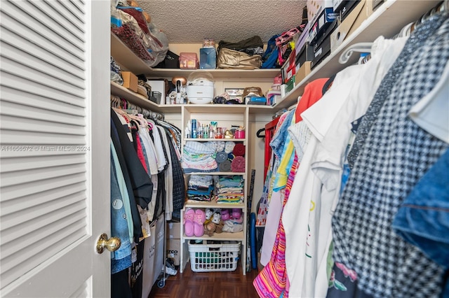 walk in closet featuring parquet floors