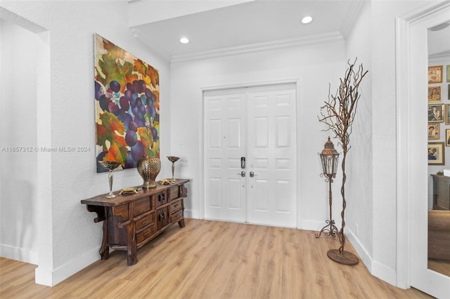 entryway with crown molding and light wood-type flooring