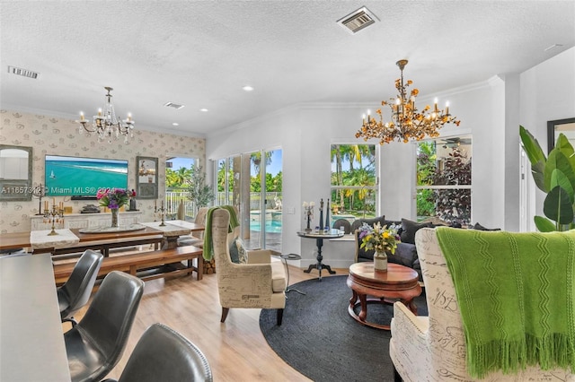 office with ornamental molding, an inviting chandelier, light wood-type flooring, and a textured ceiling