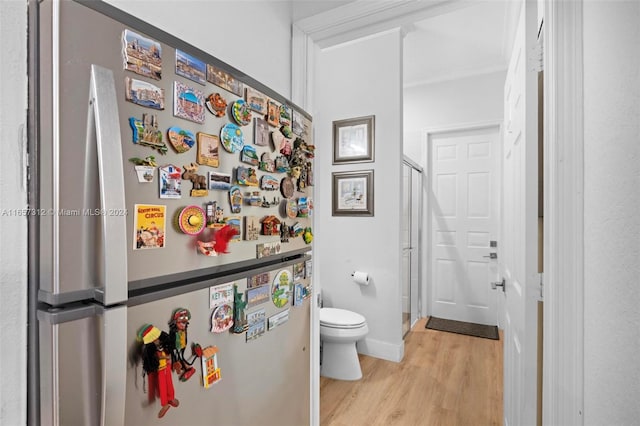 bathroom with toilet and hardwood / wood-style flooring