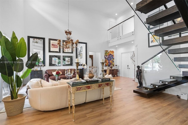 living room with light wood-type flooring and a high ceiling