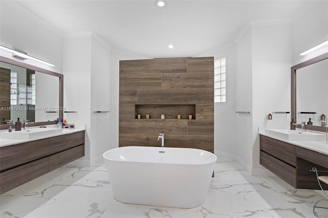 bathroom with a bath, crown molding, and vanity