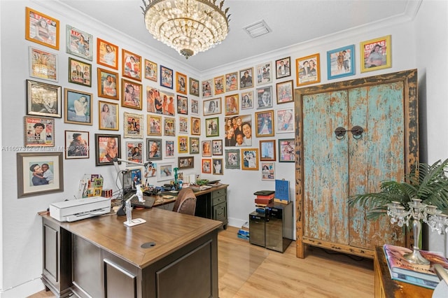 office area featuring light hardwood / wood-style floors, ornamental molding, and a notable chandelier