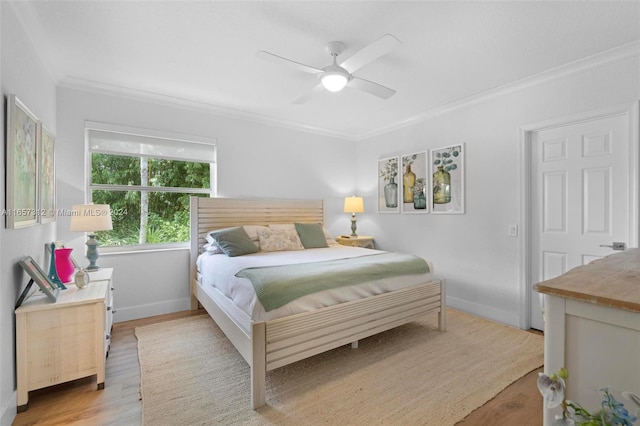 bedroom featuring crown molding, ceiling fan, and light hardwood / wood-style floors