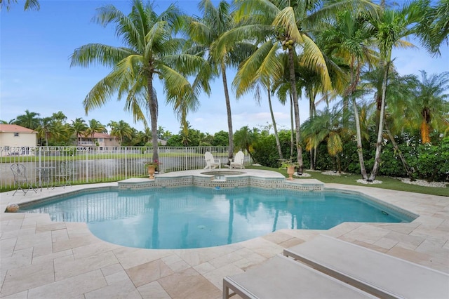 view of swimming pool featuring a patio area and an in ground hot tub