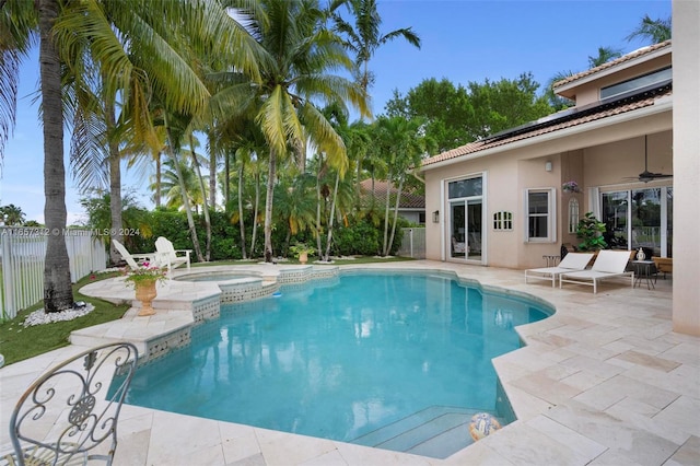 view of pool featuring ceiling fan, a patio area, and an in ground hot tub