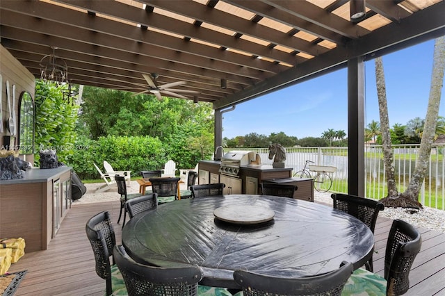 deck featuring a pergola, a grill, an outdoor kitchen, and ceiling fan