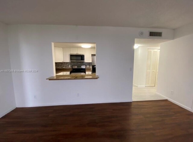 13499 Biscayne Blvd Unit 1507, North Miami, FL 33181 - unfurnished living room featuring wood finished floors and baseboards