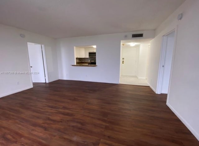 spare room with dark hardwood / wood-style floors