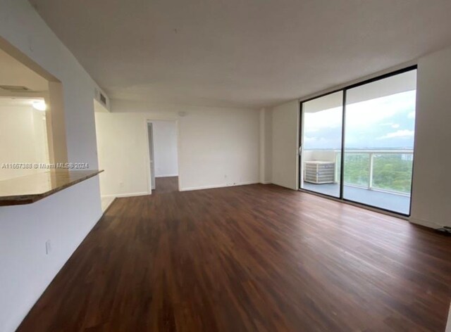 13499 Biscayne Blvd Unit 1507, North Miami, FL 33181 - empty room featuring dark wood-style floors, floor to ceiling windows, and baseboards