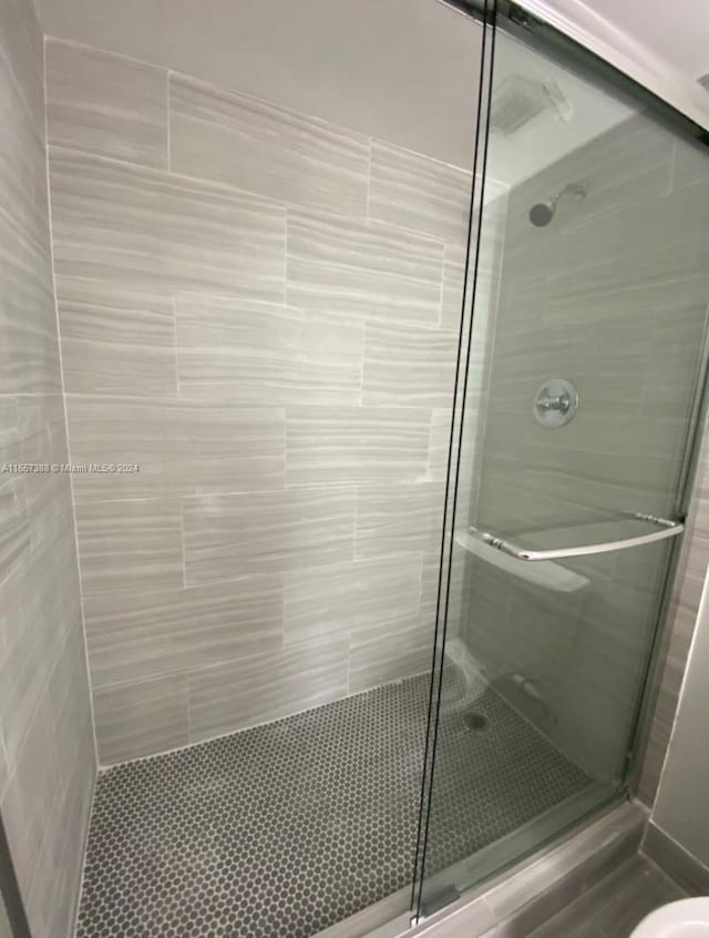 bathroom featuring a shower with shower door