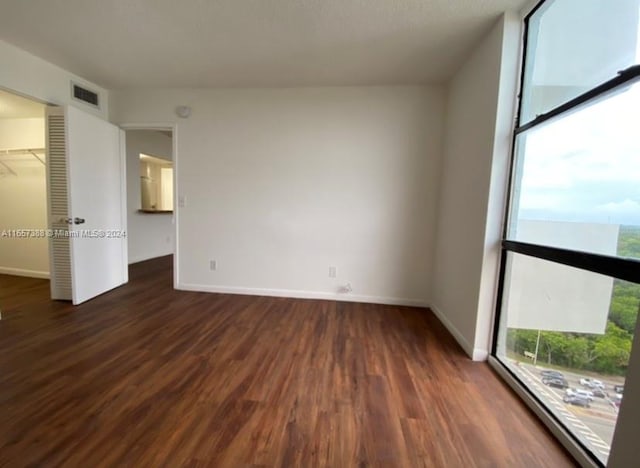 spare room with dark hardwood / wood-style floors