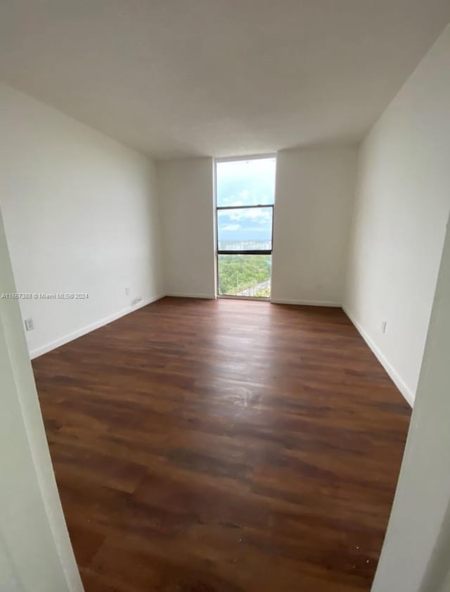 13499 Biscayne Blvd Unit 1507, North Miami, FL 33181 - empty room featuring dark wood-style flooring, baseboards, and floor to ceiling windows