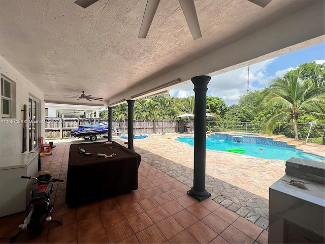 view of swimming pool with ceiling fan and a patio