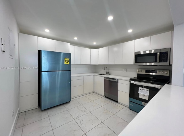 13499 Biscayne Blvd Unit 1405, North Miami, FL 33181 - kitchen with stainless steel appliances, a sink, light marble finish flooring, light countertops, and white cabinetry