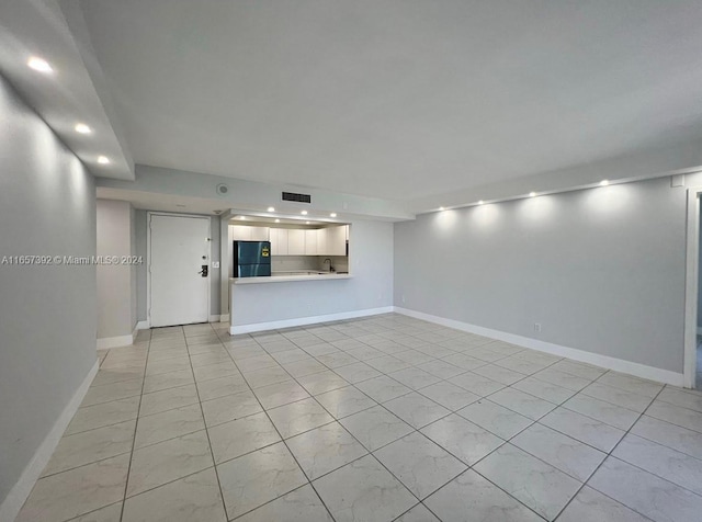 unfurnished living room with sink